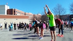 Walkers and runners do warmup exercises before the Frosty Bear walk-run, Jan. 25 at the McNamara Headquarters Complex, Fort Belvoir, Virginia.