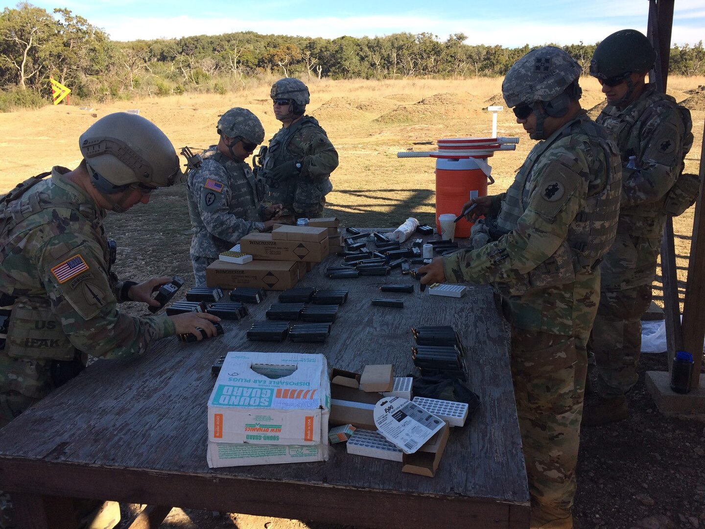 Headquarters and Headquarters Battalion U.S. Army South Soldiers from Joint Base San Antonio-Fort Sam Houston reload magazines in support of pistol marksmanship training at JBSA-Camp Bullis Jan. 24.