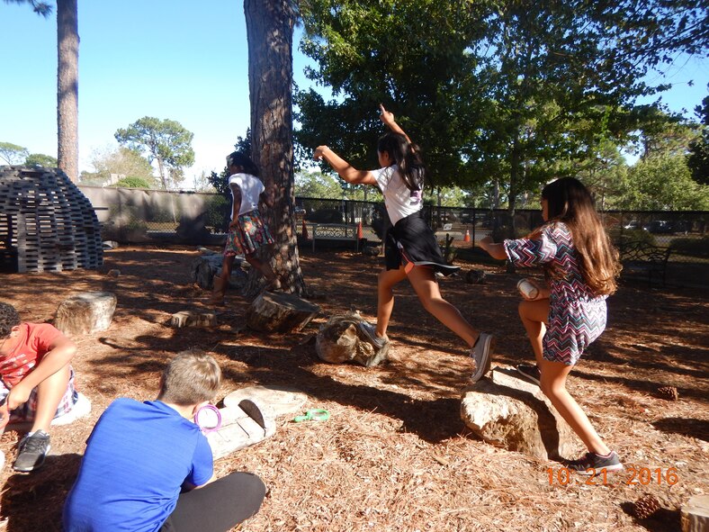 Hurlburt Field youth play in the Nature Explore outdoor classroom at the youth center on Hurlburt Field, Fla., Oct. 21, 2016. Nature Explore is a national initiative, sponsored by the Arbor Day Foundation and Dimensions Foundation in collaboration with environmental, educational, design and health organizations, meant to foster highly-effective, nature-based outdoor learning. (Courtesy photo)