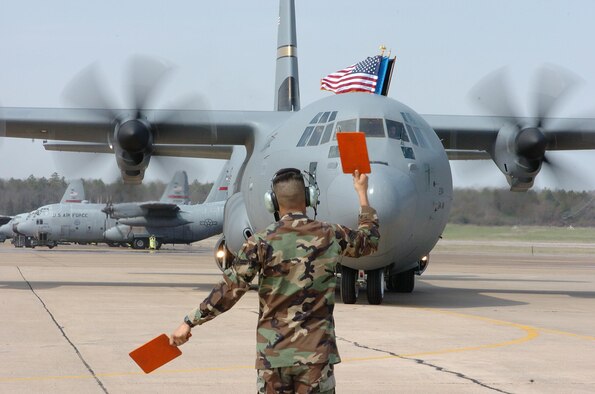 A U.S. Air Force Airman marshals the first C-130J to land March 19, 2004, at Little Rock Air Force Base, Ark. Little Rock AFB is home to the Center of Excellence, the world’s premiere C-130 training school, and is known as the Home of Combat Airlift. (U.S. Air Force photo)