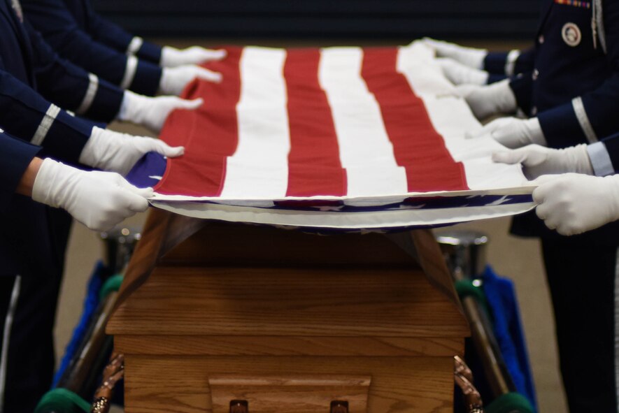 Honor guard graduates prepare to fold the American flag during a presentation on how they would conduct a military funeral at Barksdale Air Force Base, La., Jan. 23, 2017. Honor guardsmen are known to attend events which include parades, retirements, change of command ceromonies and funerals. (U.S. Air Force photo/Airman 1st Class Stuart Bright)