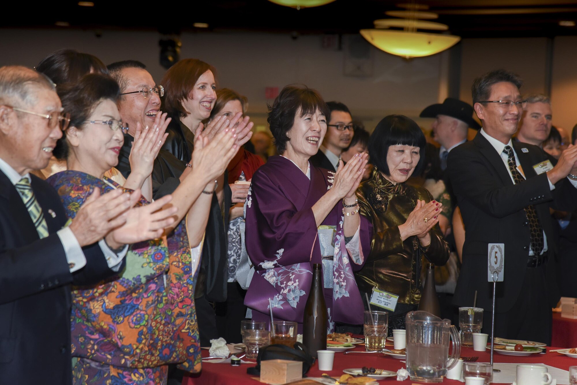 Guests clap their hands after the music performance by Mizuho youth Brass Band and the Band of the Pacific-Asia during the Joint New Year’s Party at Yokota Air Base, Japan, Jan. 21, 2017. The event was hosted by Col Kenneth Moss, commander of the 374th Airlift Wing, and the president from each of the seven friendship clubs from Fussa City, Akiruno City, Mizuho Town, Hamura City, Musashimurayama City, Ome City and Akishima City to strengthen the friendship between Yokota Air Base and each of the local communities. (U.S. Air Force photo by Machiko Arita)