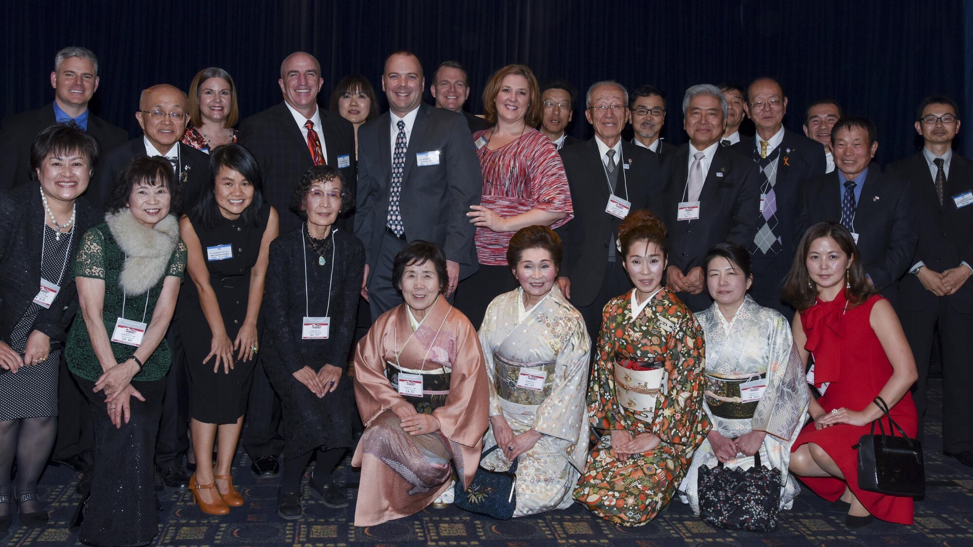 515th Air mobility Operations Group member and its counterpart Hamura-Yokota Friendship Club, along with Col. Kenneth Moss, 374th Airlift Wing commander, pose for a photo during the Joint New Year’s Party at Yokota Air Base, Japan, Jan. 21, 2017. The members concluded the event with  Japanese style hand clapping to mark the conclusion of the event.(U.S. Air Force photo by Machiko Arita)