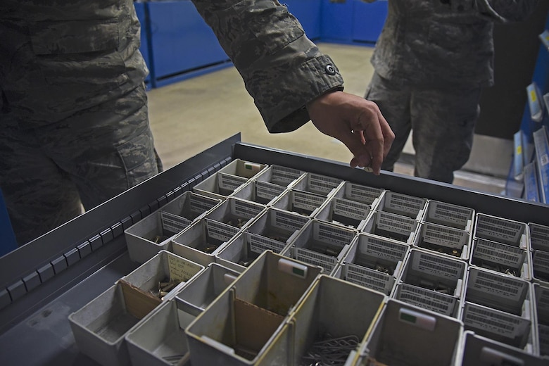 Senior Airman Nick Monroe, 92nd Maintenance Squadron periodic inspection support section journeyman, conducts daily bench stock program duties Jan. 20, 2017, at Fairchild Air Force Base, Wash. With thousands of individual fasteners in hundreds of variations, the process of updating bench stock inventory could take eight hours and since receiving the RoboCrib, the process has been reduced to less than 30 minutes. (U.S. Air Force photo/Senior Airman Mackenzie Richardson)