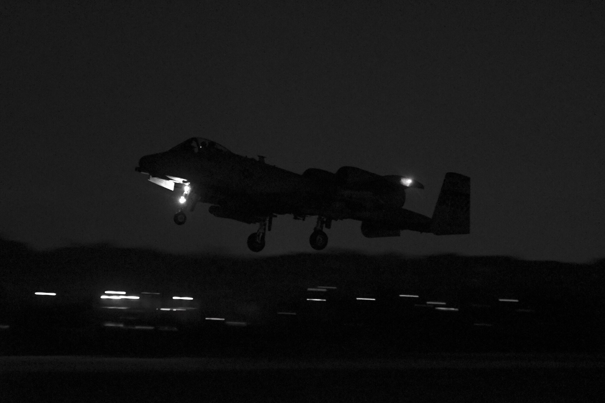 An A-10 Thunderbolt II assigned to the 25th Fighter Squadron takes off for a training mission at Osan Air Base, Republic of Korea, Jan. 25, 2017. Several A-10s were flown in the mission, which was part of Exercise Pacific Thunder 17-1 and also the first night mission in the history of the exercise. (U.S. Air Force photo illustration by Senior Airman Victor J. Caputo)