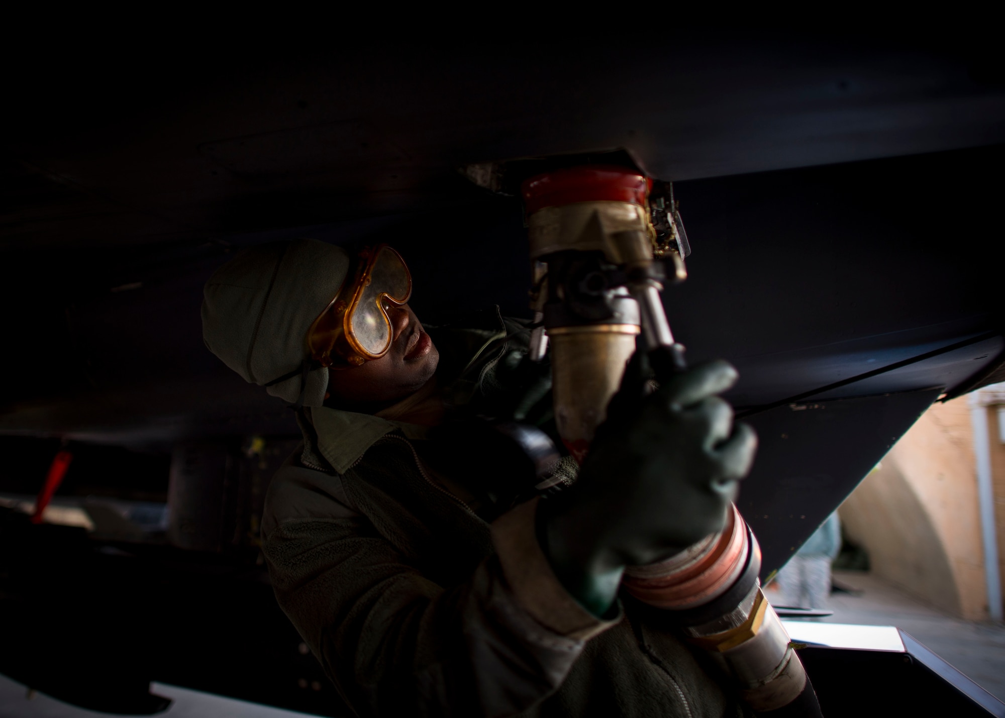 Senior Airman Travon Taylor, 332nd Expeditionary Maintenance Squadron crew chief, connects a fuel hose to an F-15E Strike Eagle, Jan. 9, 2017, in Southwest Asia. The 332nd EMXS crew chiefs are in charge of maintenance concerning the aircraft. (U.S. Air Force photo by Staff Sgt. Eboni Reams)