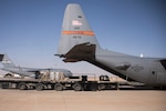 Aerial porters from the 870th Air Expeditionary Squadron push a pallet of supplies from a K-loader into the back of a C-130H Hercules at Al Asad Air Base, Iraq, Jan. 9, 2017. Aerial porters are responsible for loading and unloading aircraft and moving cargo around the cargo yard. (U.S. Air Force photo/Senior Airman Andrew Park)