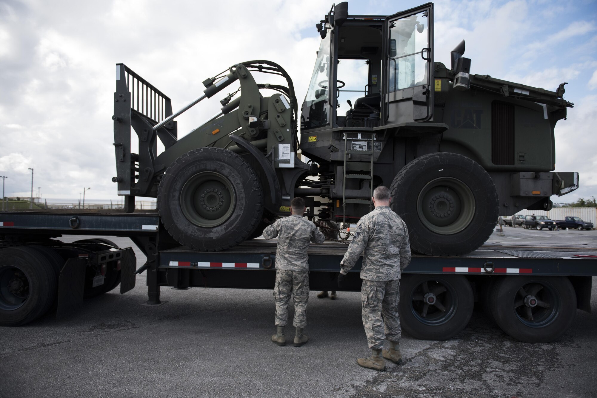 U.S. Air Force 18th Logistics Readiness Squadron vehicle operators unload a 10k all-terrain vehicle from the back of a tractor-trailer Jan. 19, 2017, at a vehicle depot on Kadena Air Base, Japan. Vehicle operators train night and day to move equipment quickly and safely. (U.S. Air Force photo by Senior Airman Omari Bernard/Released)