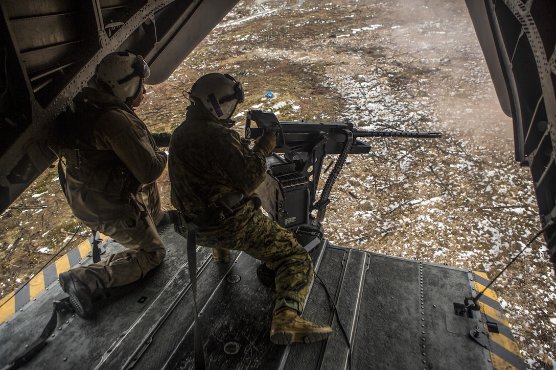 U.S. Marine Corps Sgt. Maj. Brian S. Alsleben, right, the Sergeant Major of Marine Heavy Helicopter Squadron 464, fires a .50-caliber machine gun during a course of fire above Fort Drum, N.Y., Jan. 23, 2017. HMH-464 conducted the exercise to increase the squadron’s operational readiness in extreme conditions.