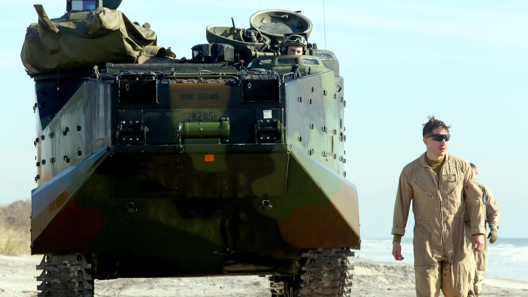 Sgt. Kevin M. Powers ground guides the operator of an assault amphibious vehicle to ensure safety during ship-to-shore operations at Camp Lejeune, N.C., Jan. 19, 2017. The training was meant to give the Marines experience operating the AAVs in the ocean. Powers is an assault amphibious vehicle crewman assigned to 2nd Assault Amphibian Battalion, 2nd Marine Division. 