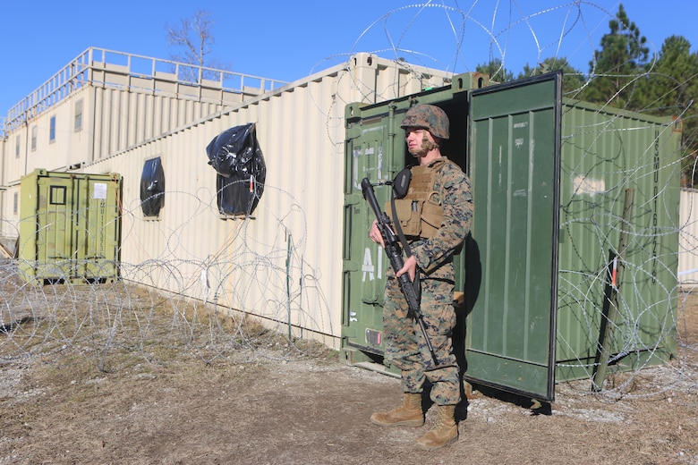 Lance Cpl. Bailey Hammanreichel stands guard in front the temporary special compartmentalized information facility at Camp Lejeune, N.C., Jan. 25, 2017. Marines with Alpha Co., 2nd Radio Battalion are participating in an embassy reinforcement exercise in order to prepare for a Special Purpose Marine Air-Ground Task Force. Hammanreichel is a ground electronics telecommunications and information technology systems maintainer with the company.