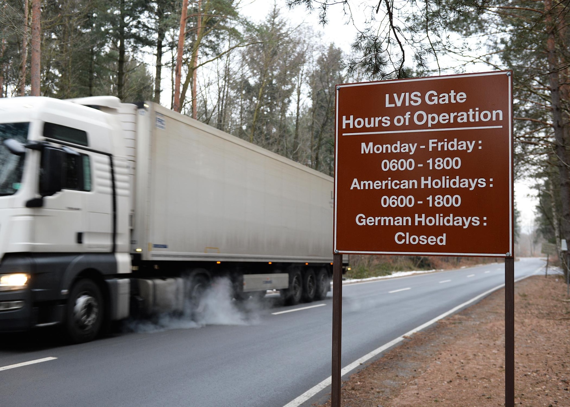 A sign displays the operating hours of the Large Vehicle Inspection Site Gate outside Ramstein Air Base, Germany, Jan. 25, 2017. The gate’s normal operating hours will not be affected by the change of traffic flow. (U.S. Air Force photo by Senior Airman Jimmie D. Pike)