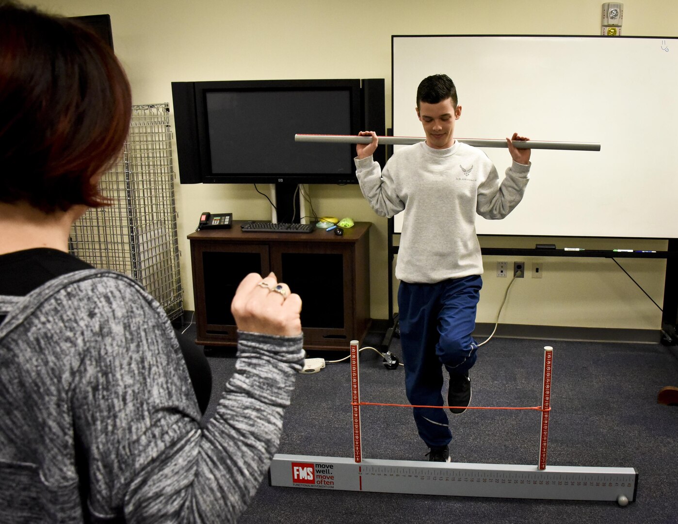 Patrice Hickey, exercise physiologist, 70th Intelligence, Surveillance, and Reconnaissance Wing, evaluates an Airman conducting a hurdle step assessment Jan. 25 at Fort George G. Meade, Maryland. The hurdle step is one of the seven movement assessments of the Functional Movement Screen, which is part of the Meeting Mission Objectives via Exercises (MOVE) program. FMS uses seven different assessments to identify weak and improper movement patterns. (U.S. Air Force photo/Staff Sgt. AJ Hyatt)