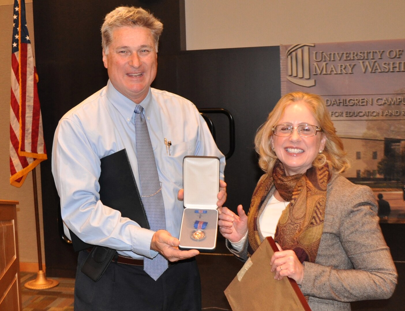 DAHLGREN, Va. (Jan. 17, 2017)— Naval Surface Warfare Center Dahlgren Division (NSWCDD) Operations Department Head Mike Purello presents the Department of the Navy Meritorious Civilian Service Medal to Janet Day at a ceremony held at the University of Mary Washington Dahlgren campus. “I always learned from the organizations I support,” said Day, who was honored for her exemplary support to four Naval Sea Systems Command field activities. “These organizations and the incredibly talented, hard-working and professional military, civilians, and contractors who perform their mission on a day-to-day basis were a pleasure to work with, and for, and I thank them for the opportunity."     