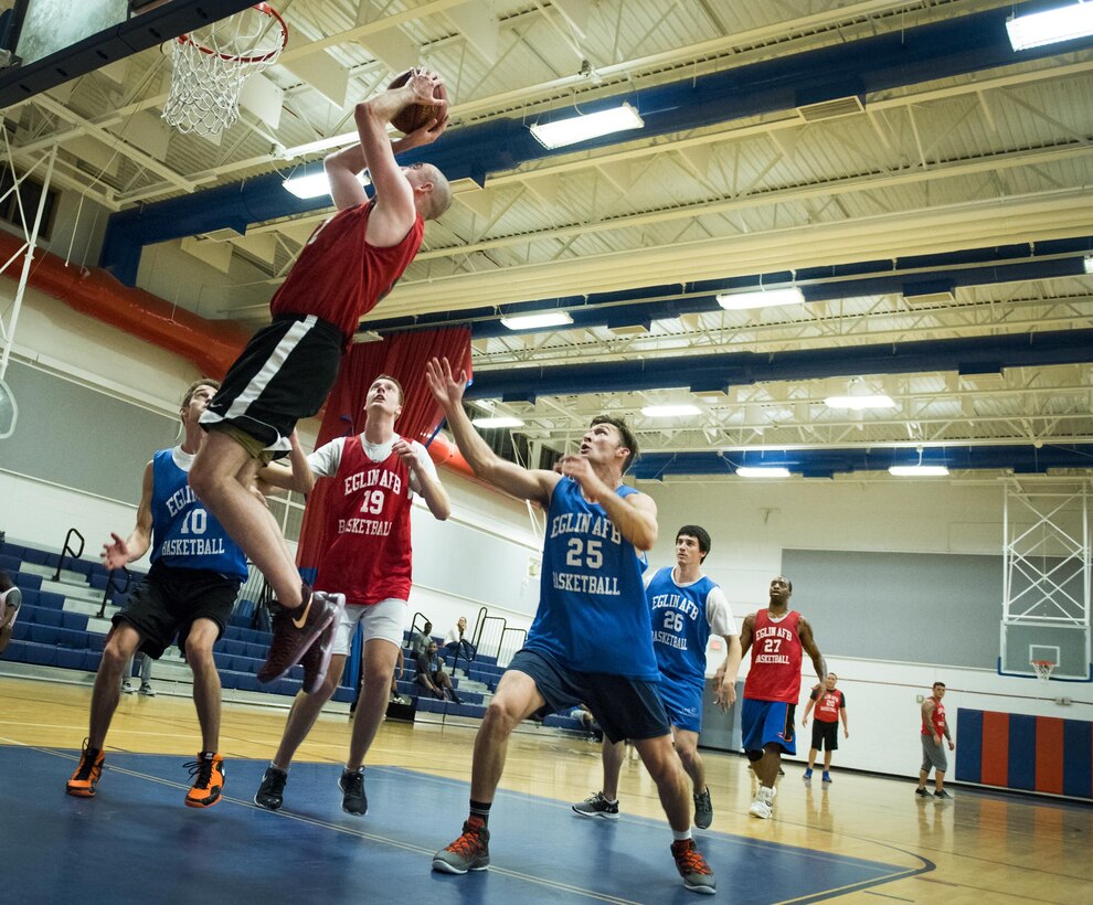 The 592nd Special Operations Maintenance Squadron’s Adam Cummings puts the ball back up toward the goal after a rebound during his team’s intramural basketball game Jan. 24 at Eglin Air Force Base Fla.  The maintainers easily controlled the game using their height advantage over the Air Force Research Lab team.  The Duke Field-stationed team rolled to a 2-0 season start with the 41 – 32 victory.  (U.S. Air Force photo/Samuel King Jr.)