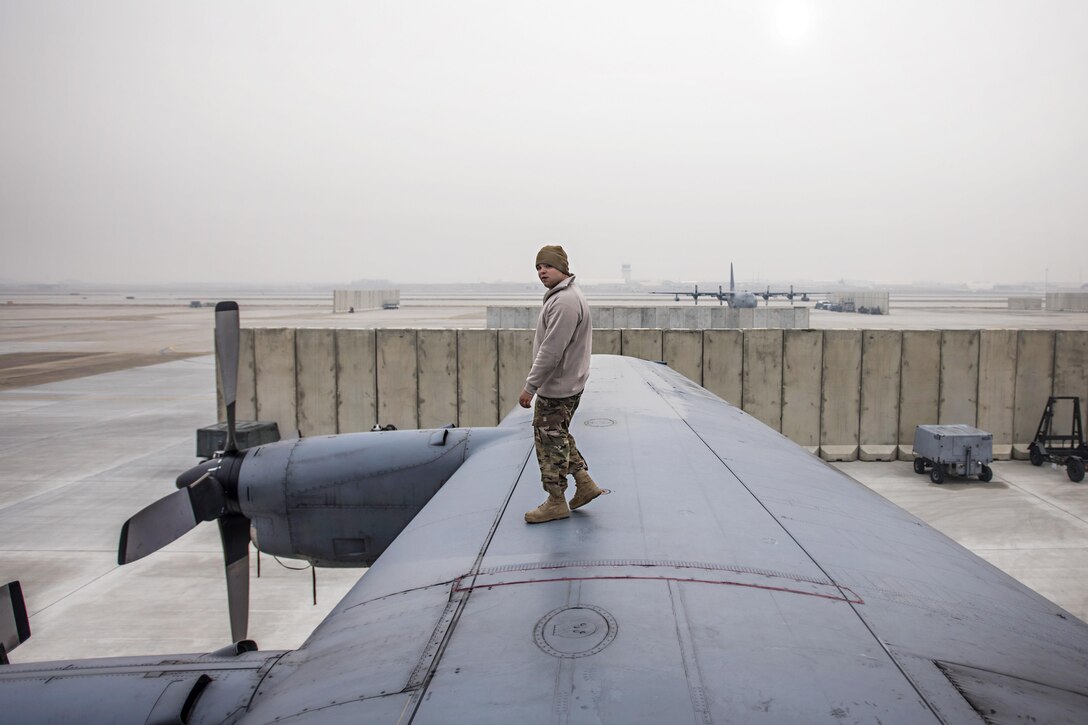 Air Force Staff Sgt. Sean Nelson walks along the wing of an EC-130 Compass Call during scheduled maintenance at Bagram Airfield, Afghanistan, Jan. 18, 2017. Nelson is a crew chief assigned to the 455th Expeditionary Aircraft Maintenance Squadron. Air Force photo by Staff Sgt. Katherine Spessa