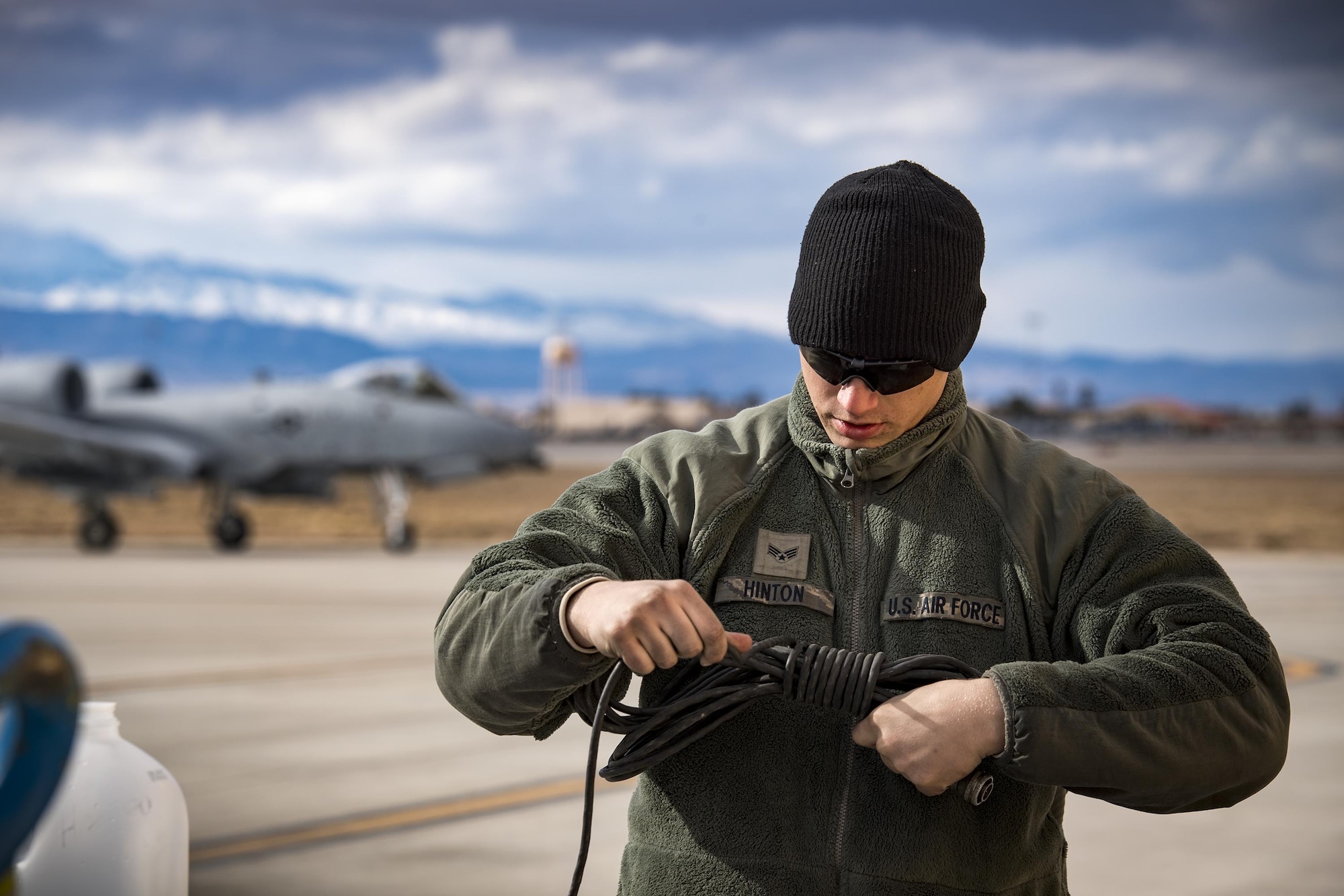 Senior Airman Eric Hinton, 74th Aircraft Maintenance Unit crew chief, wraps a communications cord as an A-10C Thunderbolt II taxis to the flightline during Green Flag-West 17-03, Jan. 23, 2017, at Nellis Air Force Base, Nev. GFW is an air-land integration combat training exercise, which hosted 12 A-10s from Moody Air Force Base, Ga. Accompanying the aircraft were 130 maintenance personnel who worked around the clock to launch 18 sorties per day. (U.S. Air Force photo by Staff Sgt. Ryan Callaghan)