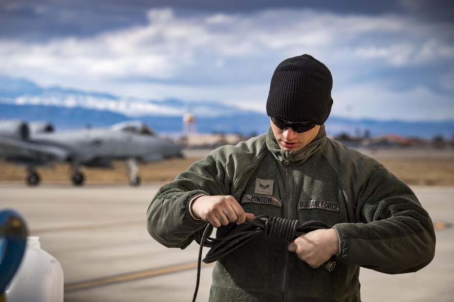 Senior Airman Eric Hinton, 74th Aircraft Maintenance Unit crew chief, wraps a communications cord as an A-10C Thunderbolt II taxis to the flightline during Green Flag-West 17-03, Jan. 23, 2017, at Nellis Air Force Base, Nev. GFW is an air-land integration combat training exercise, which hosted 12 A-10s from Moody Air Force Base, Ga. Accompanying the aircraft were 130 maintenance personnel who worked around the clock to launch 18 sorties per day. (U.S. Air Force photo by Staff Sgt. Ryan Callaghan)