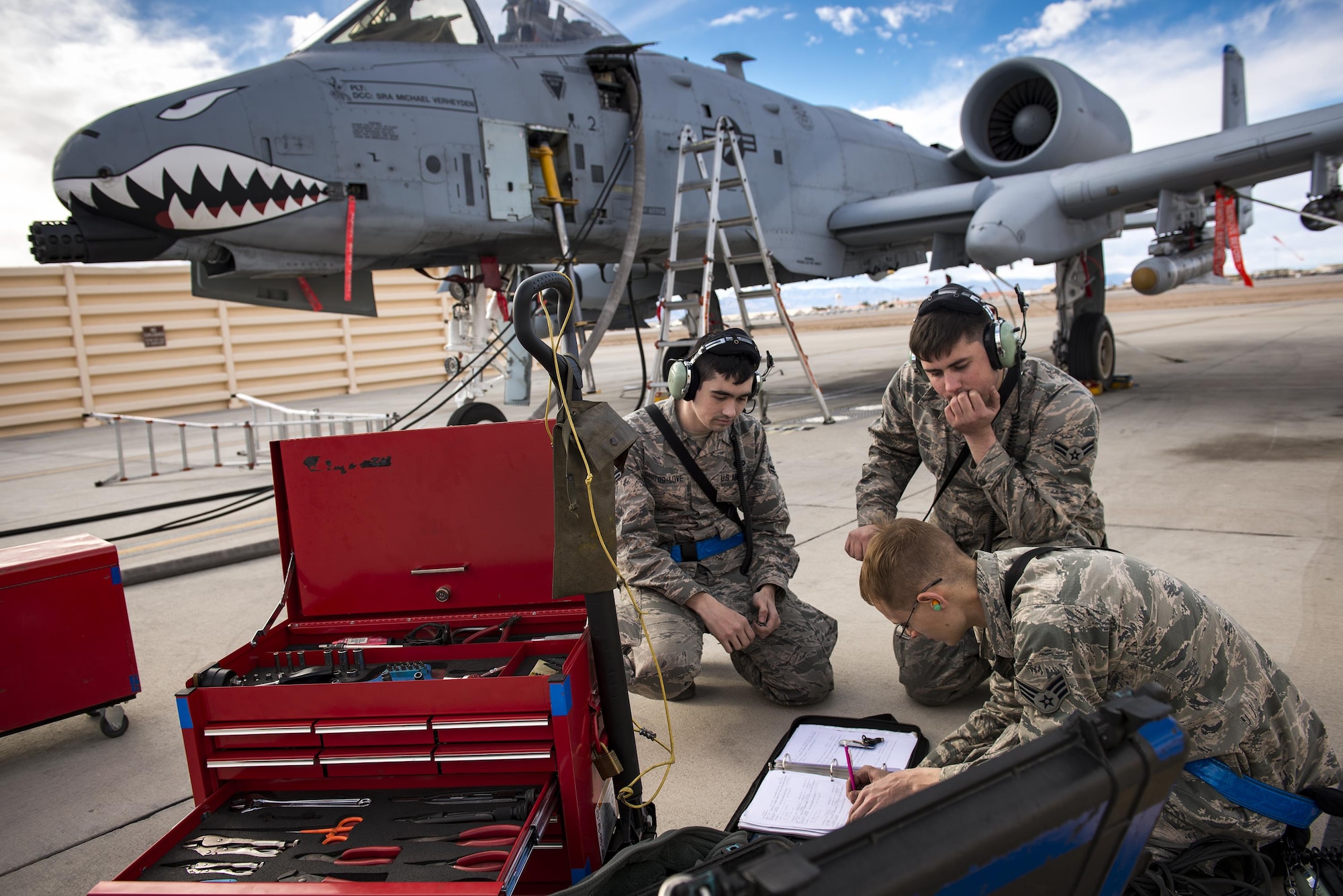 Airmen from the 74th Aircraft Maintenance Unit document maintenance they completed on an A-10C Thunderbolt II during Green Flag-West 17-03, Jan. 23, 2017, at Nellis Air Force Base, Nev. GFW is an air-land integration combat training exercise, which hosted 12 A-10s from Moody Air Force Base, Ga. Accompanying the aircraft were 130 maintenance personnel who worked around the clock to launch 18 sorties per day. (U.S. Air Force photo by Staff Sgt. Ryan Callaghan)