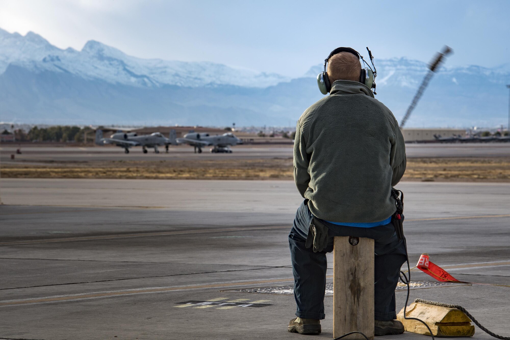 Senior Airman Cody Campbell, 74th Aircraft Maintenance Unit crew chief, swings the rope on a tire-chalk while waiting for an A-10C Thunderbolt II to return from the end of the runway during Green Flag-West 17-03, Jan. 23, 2017, at Nellis Air Force Base, Nev. GFW is an air-land integration combat training exercise, which hosted 12 A-10s from Moody Air Force Base, Ga. Accompanying the aircraft were 130 maintenance personnel who worked around the clock to launch 18 sorties per day. (U.S. Air Force photo by Staff Sgt. Ryan Callaghan)