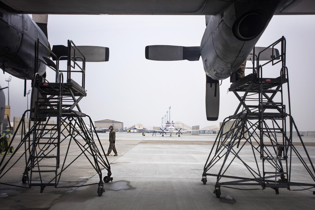 Air Force Staff Sgt. Kyle Poston watches his team members perform engine maintenance on an EC-130 Compass Call aircraft at Bagram Airfield, Afghanistan, Jan. 18, 2017. Air Force photo by Staff Sgt. Katherine Spessa