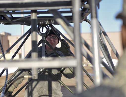 Senior Airman Matthew Nielson, a logistic specialist assigned to the 28th Logistic Readiness Squadron, coordinates with another Airman while loading a platform onto a truck Jan. 17, 2017, at Ellsworth Air Force Base, S.D. Platforms, generators, flood lights and other equipment will be used at Red Flag 17-1, an Air Force-wide exercise testing air-to-air combat. (U.S. Air Force photo/Airman 1st Class Randahl J. Jenson)