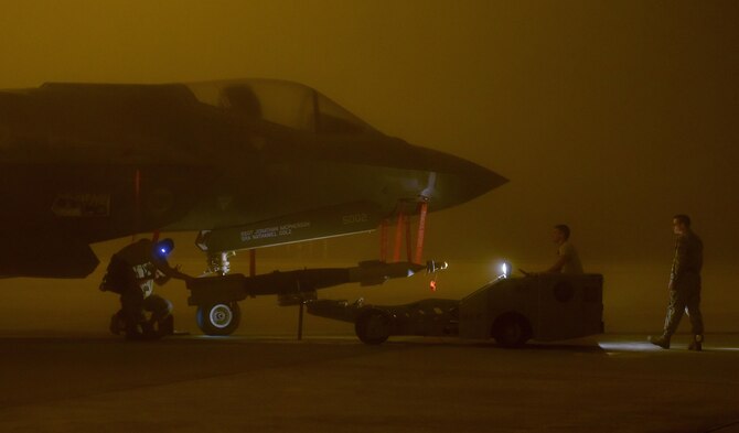 An Air Force weapons load crew assigned to the 33rd Aircraft Maintenance Squadron loads a live GBU-12 into an F-35A Lightning II Jan. 18, 2017, at Eglin Air Force Base, Fla. The 33rd Fighter Wing loaded and released the Air Education and Training Command’s first live bombs from an F-35A. (U.S. Air Force photo/Staff Sgt. Peter Thompson)