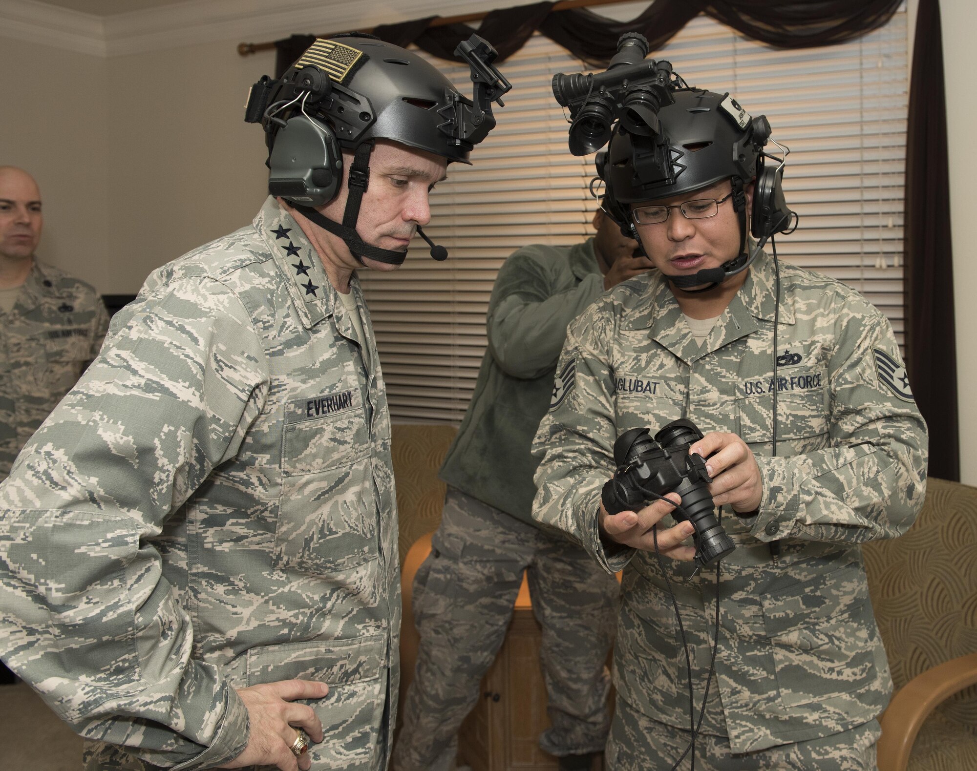 Gen. Carlton D. Everhart II, Air Mobility Command commander, Scott Air Force Base, Ill., receives training on the night optical/observation device from Staff Sgt. Jason Aglubat, 60th Ariel Port Squadron, Jan. 17, Travis Air Force Base, Calif. During his four day tour, Gen. Everhart met with senior leadership and leaders from the surrounding community, visited several base units and spoke with many Travis Airmen.   (U.S. Air Force photo/ Heide Couch)