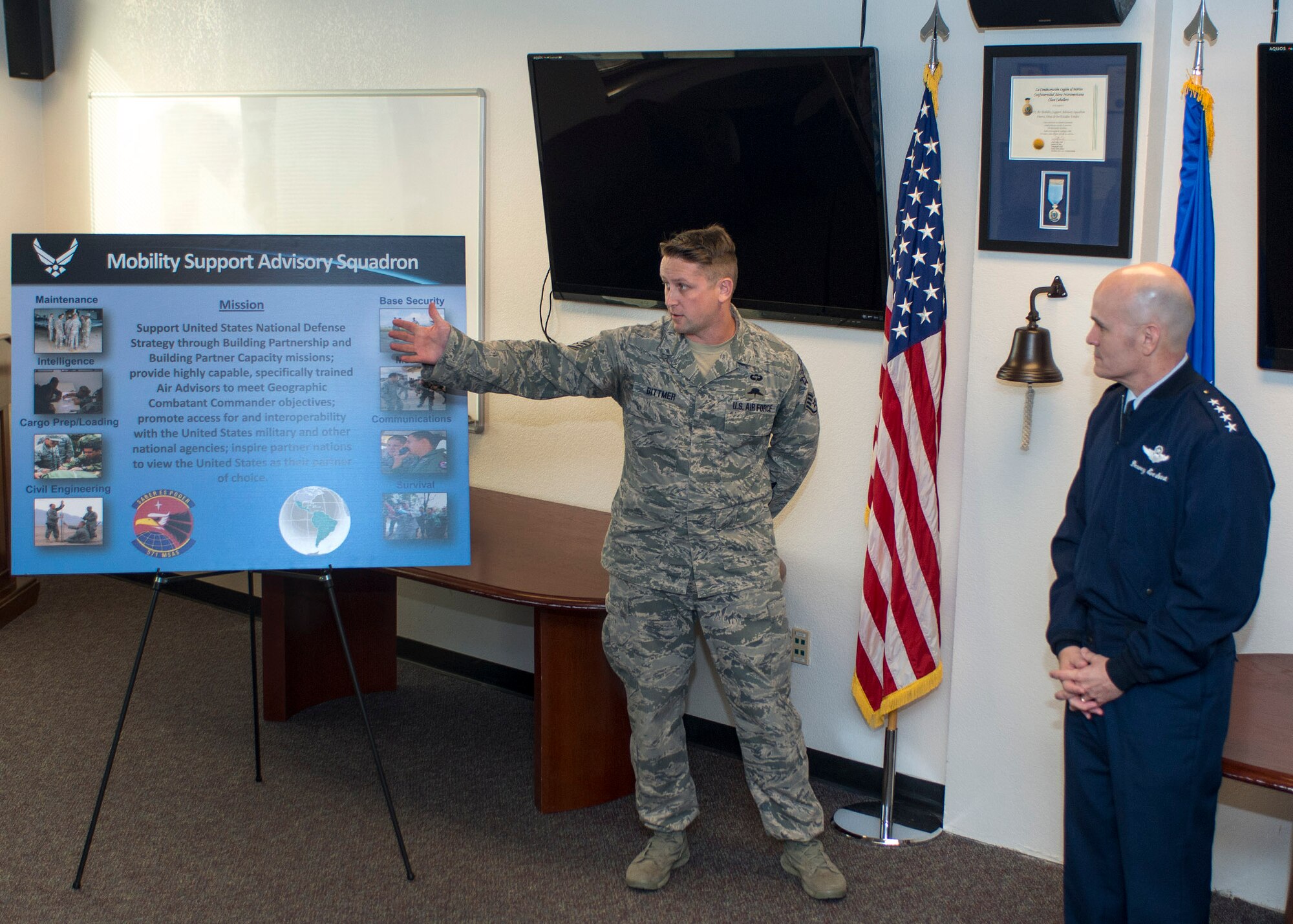 Staff Sgt. Joe Dittmer, 571st Mobility Support Advisory Squadron, briefs Gen. Carlton D. Everhart II, Air Mobility Command commander, Scott Air Force Base, Ill. on the unit’s recent deployment, Jan. 19, at Travis Air Force Base, Calif.  Everhart's four-day visit included a tour of the 621st Contingency Response Wing as well as the 60th Air Mobility Wing.  (US Air Force  photo/T.C. Perkins Jr.)