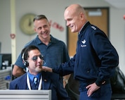 U.S. Air Force Gen. Carlton D. Everhart II, Air Mobility Command commander, Scott Air Force Base, Ill., talks with Amir Ghohremani during his tour of the 60th Communications Squadron, Travis Air Force Base, Calif., Jan. 19, 2017. Everhart is on a four-day tour to Travis visiting with airmen, observing operations and meeting with civic leaders. (U.S. Air Force photo/Louis Briscese)