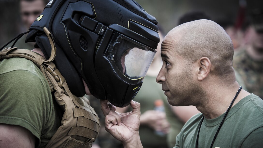 Marine Corps Sgt. Maj. Willy D. Carrion, right, speaks with Lance Cpl. Connor W. Gunnip, during the Spartan Cup, a semi-annual field event to improve unit cohesion, at Marine Corps Air Station Cherry Point, N.C., Jan. 20, 2017. Marine Corps photo by Lance Cpl. Zachary M. Ford