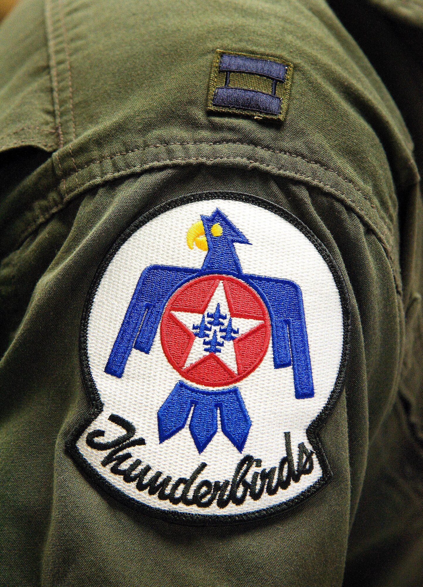 The U.S. Air Force Thunderbirds patch is worn on the flight suit of Capt. Erik "Speedy" Gonsalves, U.S. Air Force Thunderbirds advance pilot/narrator, Jan. 25, 2017, at Dover Air Force Base, Del. Gonsalves, along with Staff Sgt. Todd Hughes, tactical aircraft maintainer, visited Dover AFB to conduct a site survey for Dover's upcoming open house, scheduled for the last weekend in August. (U.S. Air Force photo by Roland Balik)