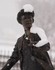 Snow settles on a statue of Wilbur Wright, part of a sculpture of the Wright Flyer, Dec. 13, 2016, near a gate to Wright-Patterson Air Force Base, Ohio. The first significant snowfall of the season blanketed the area, giving the landscape a sense of the holidays. (U.S. Air Force photo by R.J. Oriez/Released)