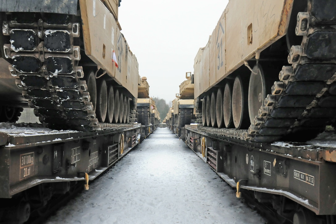 M1A2 Abrams tanks sit on a flatcar railway in Zagan, Poland, Jan. 25, 2017. The vehicles were bound for Grafenwoehr, Germany, for us by soldiers conducting training as part of Operation Atlantic Resolve. Army photo by Staff Sgt. Corinna Baltos
