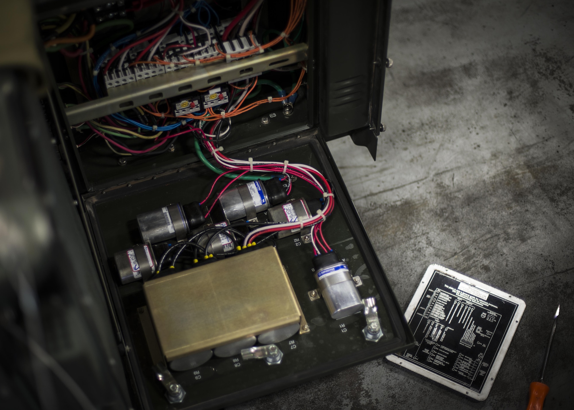 An air conditioning unit’s electrical panel and a technical order are pictured at the 49th Maintenance Squadron Aerospace Ground Equipment’s shop at Holloman Air Force Base, N.M., on Jan. 12, 2017. Holloman’s AGE Airmen perform a wide variety of maintenance duties in support of aircraft maintenance and flying operations. They inspect, test and operate AGE, from air conditioners to complex generators, to ensure equipment serviceability. (U.S. Air Force photo by Airman 1st Class Alexis P. Docherty) 