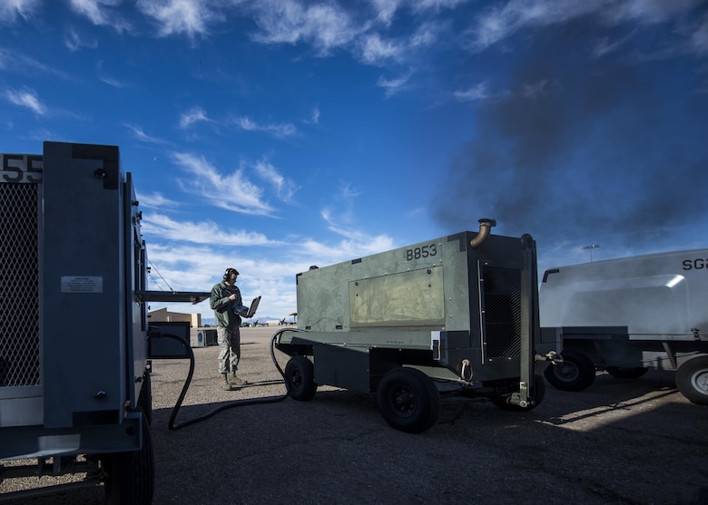 Senior Airman Justin Graham, a 49th Maintenance Squadron Aerospace Ground Equipment technician, reads a technical order while inspecting a piece of AGE at Holloman Air Force Base, N.M., on Jan. 19, 2017. Holloman’s AGE Airmen perform a wide variety of maintenance duties in support of aircraft maintenance and flying operations. (U.S. Air Force photo by Airman 1st Class Alexis P. Docherty)