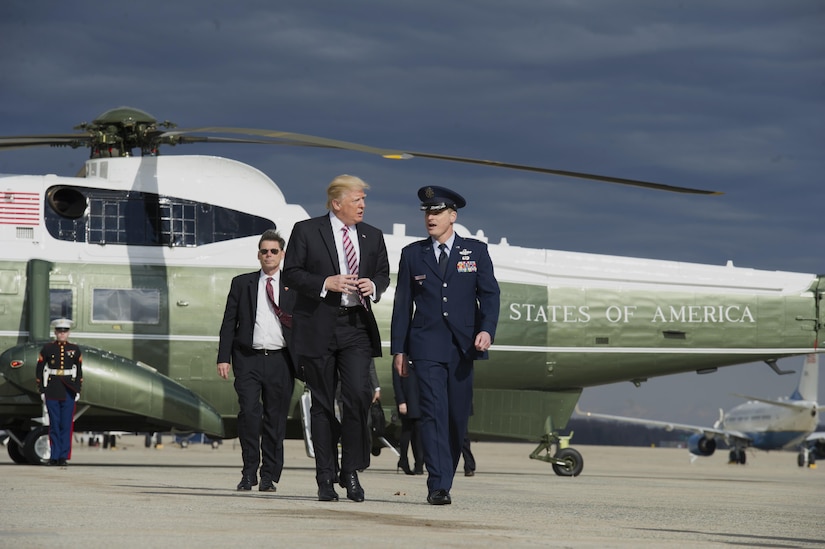 President Donald Trump speaks with Col. Christopher Thompson, 89th Airlift Wing vice commander, at Joint Base Andrews, Md., Jan. 26, 2017.Trump departed for Philadelphia to address the Congressional Grand Old Party Retreat. (U.S. Air Force photo by Senior Airman Mariah Haddenham)