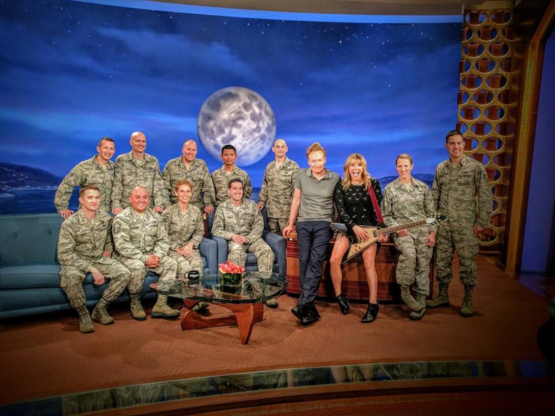 Members of the U.S.A.F. Full Spectrum pose with late-night talk show host Conan O'Brien and guest vocalist Grace Potter, prior to performing a special Veteran's tribute on Nov 10, 2016.