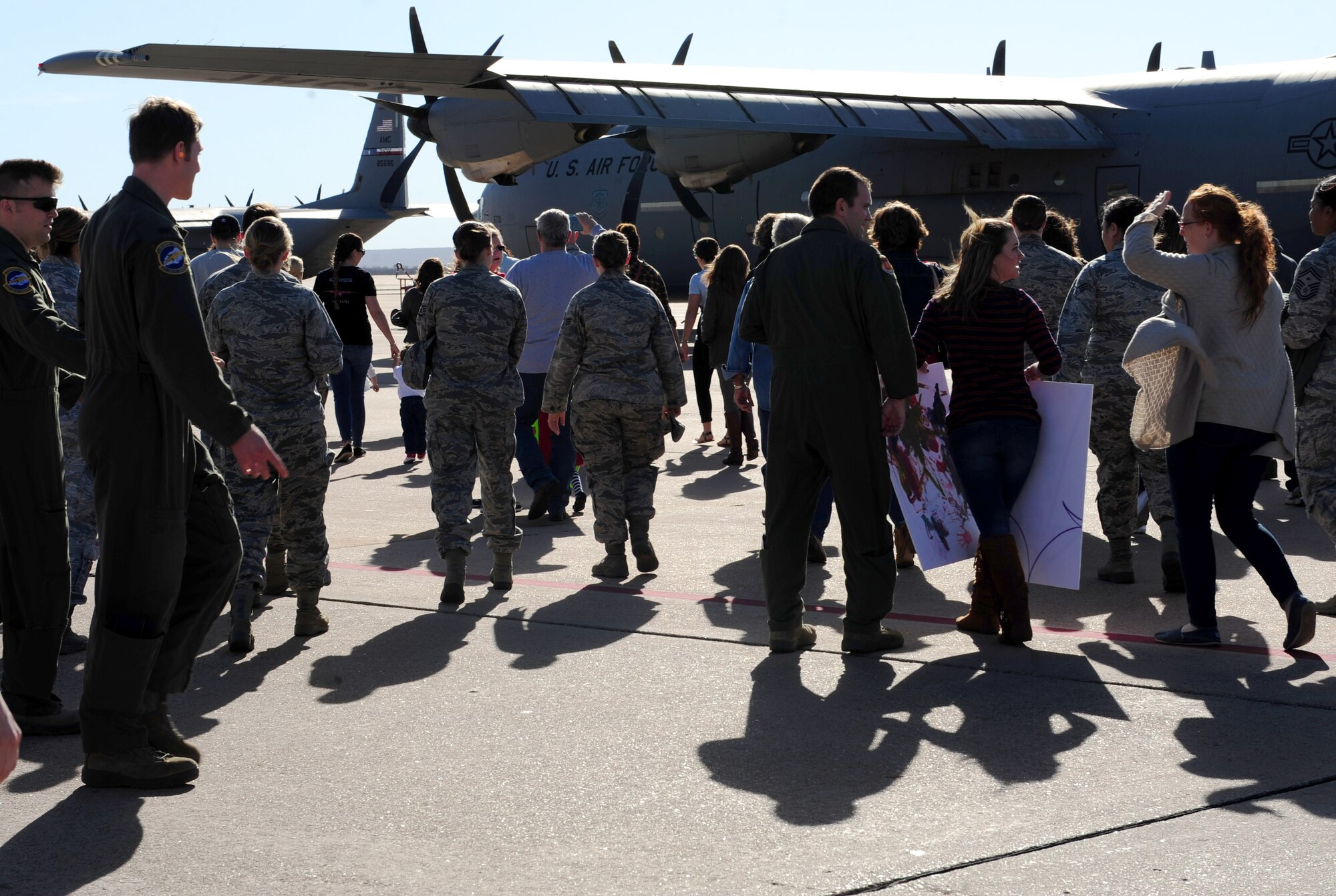 Dyess Airmen, friends and families rush to a C-130J Super Hercules to greet returning deployers at Dyess Air Force Base, Texas, Jan. 20, 2017. More than 50 Airmen and four C-130s returned to Dyess after supporting operations in Africa and Germany for four months. 