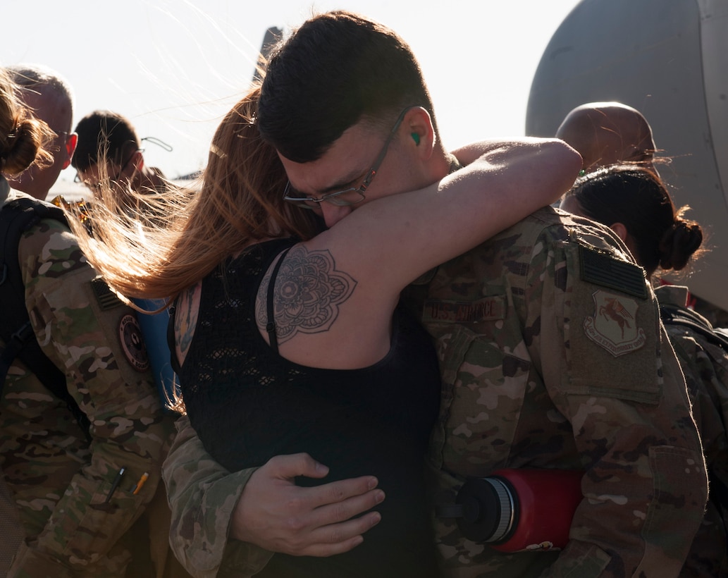 U.S. Air Force Airman 1st Class Edward Koren, 317th Aircraft Maintenance Squadron communication navigation maintenance specialist, embraces a loved one at Dyess Air Force Base, Texas, Jan. 20, 2017. Dyess aircrews have a rotational deployment schedule, which provides combat-delivery capabilities through tactical airlift and airdrop operations as well as supporting global humanitarian efforts. 