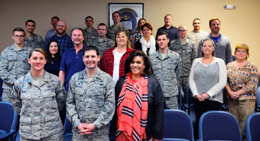 Maj. Jeremiah Kirschman, front center, 341st Contracting Squadron commander, poses for a photo with members of his team Dec. 21, 2016, at Malmstrom Air Force Base, Mont. Kirschman received the 2016 Air Force Global Strike Command Outstanding Contracting Officer Award in the field grade officer category for being both an outstanding leader. (U.S. Air Force photo/Airman 1st Class Magen M. Reeves)