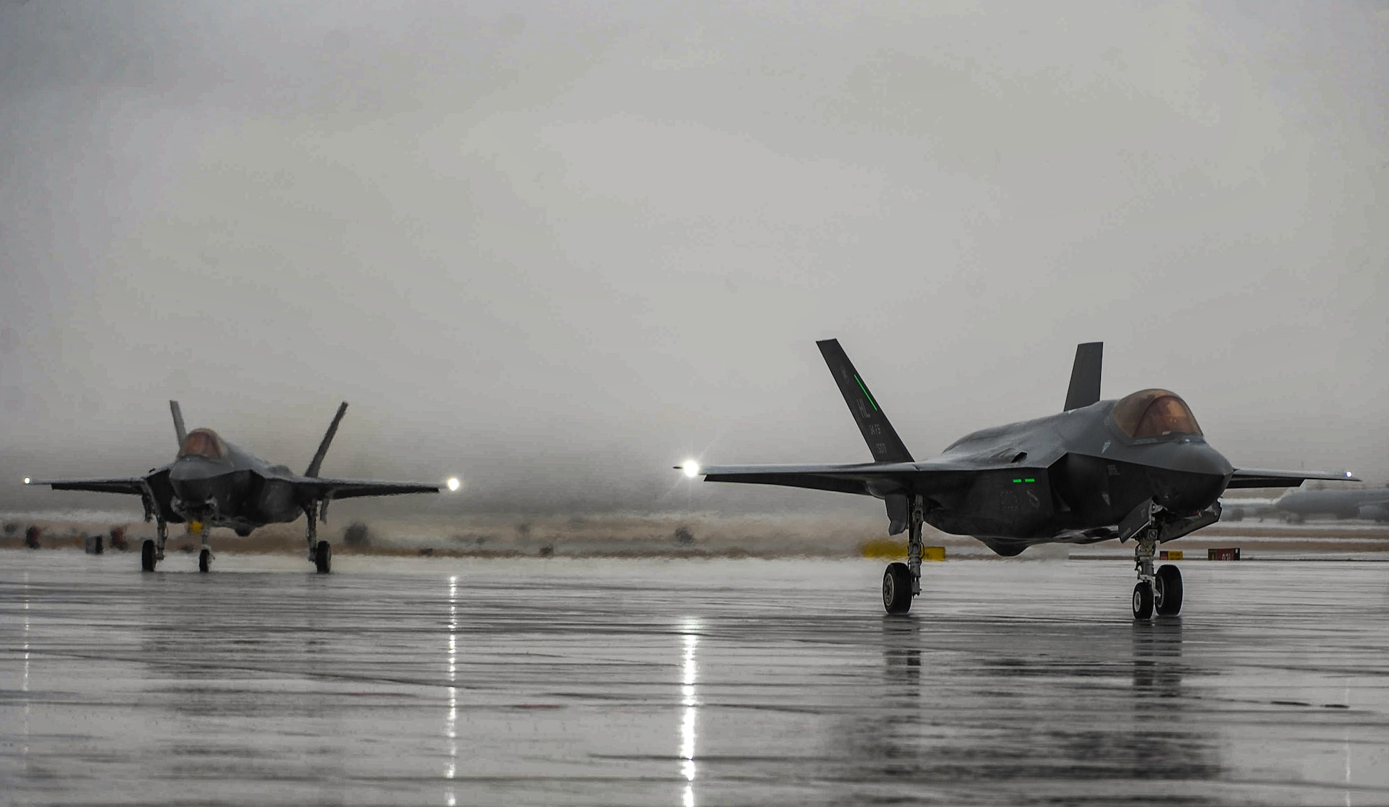Two F-35A Lightning IIs assigned to Hill Air Force Base, Utah, taxi after landing at Nellis Air Force Base, Nev., to participate in Red Flag 17-1, Jan. 21, 2017. Red Flag is a realistic combat exercise involving U.S. and allied air forces conducting training operation on the 15,000 square mile Nevada Test and Training Range. (U.S. Air Force photo by Airman 1st Class Kevin Tanenbaum/Released)