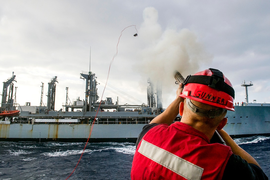 Navy Seaman Dylan Weisart fires a shot line from the USS Lake Champlain to fleet replenishment oiler USNS Guadalupe during a replenishment in the Pacific Ocean, Jan. 18, 2017. The guided-missile cruiser is on a regularly scheduled Western Pacific deployment as part of the U.S. Pacific Fleet-led initiative to extend the command and control functions of the U.S. 3rd Fleet in the Indo-Asia-Pacific region. Weisart is a gunner's mate. Navy photo by Petty Officer 2nd Class Nathan K. Serpico