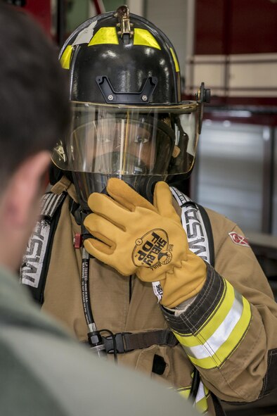 U.S. Air Force Airman 1st Class Daronda Marsh, right, a customer support technician with the 35th Force Support Squadron, straps on and checks the seal of her self-contained breathing apparatus, or SCBA, as Airman 1st Class Thomas Ulrich, left, a firefighter with the 35th Civil Engineer Squadron, walks her through the process at Misawa Air Base, Japan, Jan. 26, 2017. Marsh jumped at the opportunity to join five other Airmen who took part in Misawa’s first-ever career field exchange and shadow program. The initiative affords service members of all ranks from across the installation an opportunity to live a day in another’s boots. (U.S. Air Force photo by Staff Sgt. Benjamin W. Stratton)