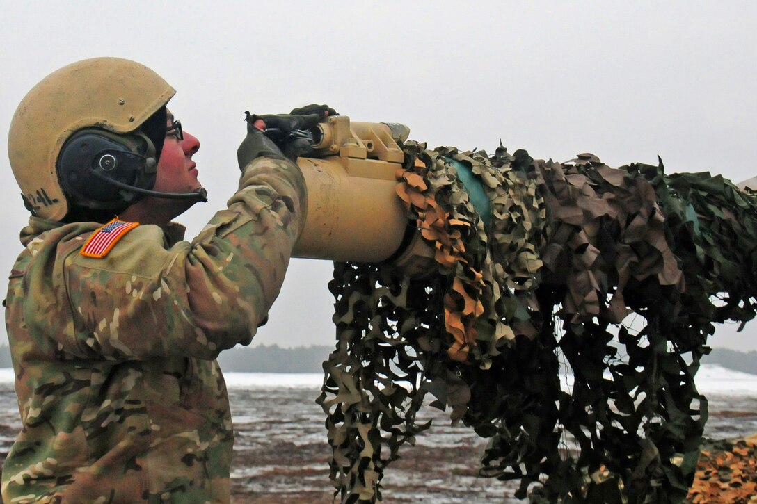 Army Spc. Dustin Salafani puts a new battery in his tank’s muzzle reference sensor during gunnery firing in Trzebien, Poland, Jan. 26, 2017. Salafani is assigned to the 4th Infantry Division's Company A, 1st Battalion, 68th Armored Regiment, 3rd Armored Brigade.  Army photo by Staff Sgt. Corinna Baltos