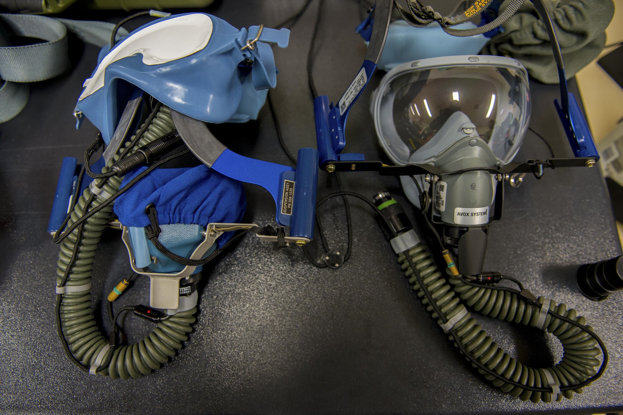 An old model quick-dawn oxygen mask sits on a table left of the new quick-dawn mask at the 374th Operations Support Squadron Aircrew Flight Equipment flight main shop Jan. 20, 2017, at Yokota Air Base, Japan. The new quick-dawn oxygen mask will replace the old on the new C-130J Super Hercules scheduled to arrive at Yokota this year. (U.S. Air Force photo by Airman 1st Class Donald Hudson)