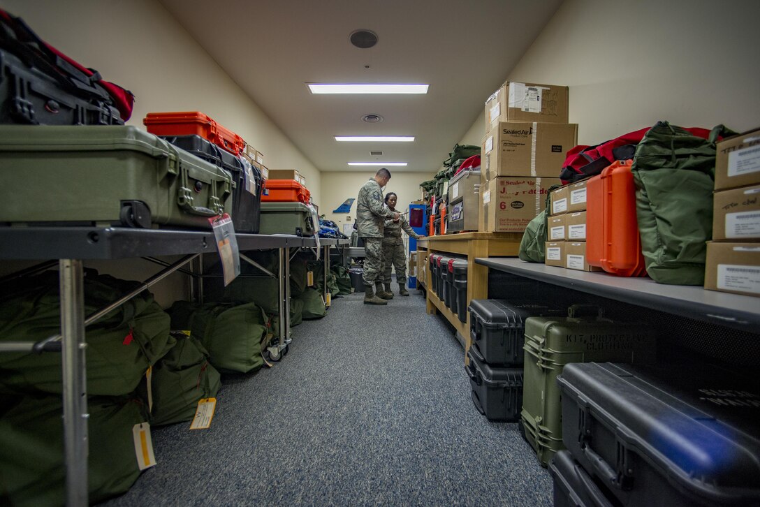 Tech Sgt. Shakuntala M. Willis, 374th Operations Support Squadron Aircrew Flight Equipment flight NCO in charge of the C-130J transition, coordinates with Master Sgt. Brock A. Atchley, 374th OSS AFE flight NCOIC, on the status of new aircrew life-support and survival gear Jan. 25, 2017, at Yokota Air Base, Japan. The AFE flight has been preparing aircrew survival and life-support equipment for the arrival of the new C-130J Super Hercules since May 2016. (U.S. Air Force photo by Airman 1st Class Donald Hudson)