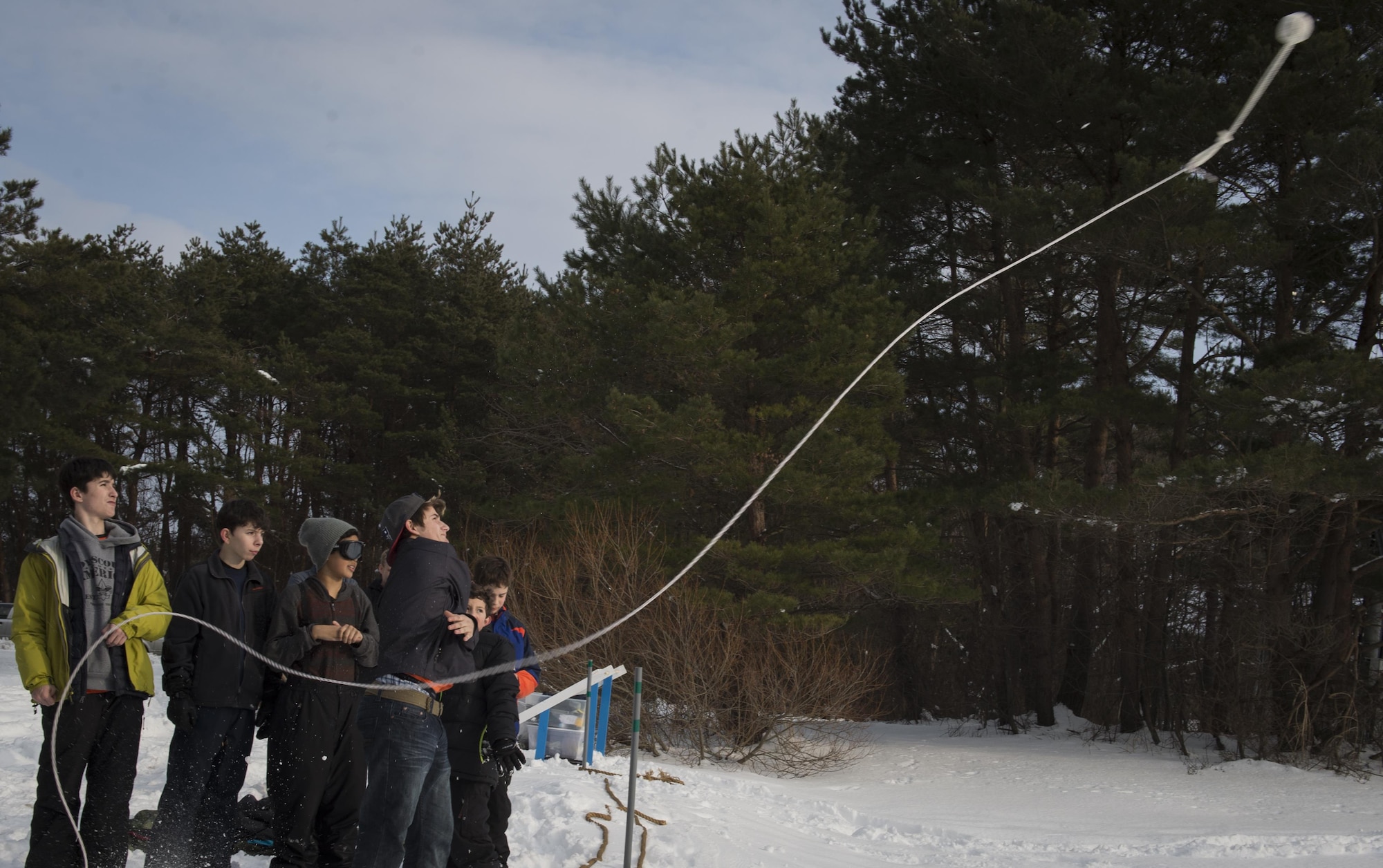 Dynamite-Viper Patrol from Troop 14 throws a rope during the Klondike Derby at Misawa Air Base, Japan, Jan. 20, 2017. The boys learned how to rescue a stranded person in cold water by using a rope and pulling them to a safe location. The Klondike Derby taught tent setup, fire buring, first aid and other surival skills to help overcome the dangers of a cold environment. (U.S. Air Force photo by Tech. Sgt. Araceli Alarcon)