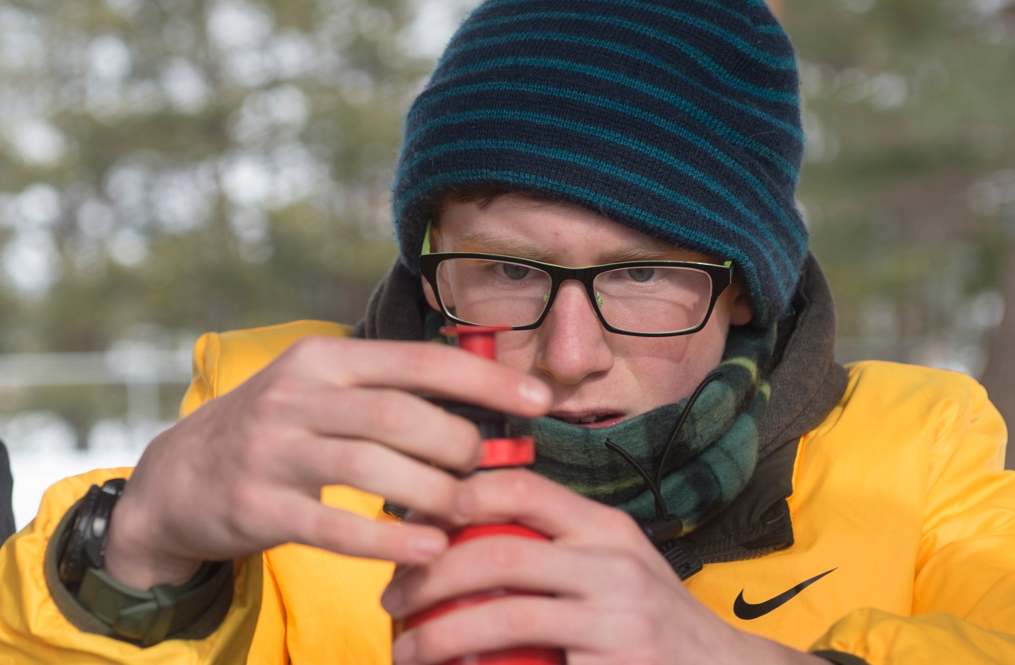 James, son of Capt. Kevan Long with the 35th Medical Operations Squadron, prepares a fuel bottle for use during the Klondike Derby at Misawa Air Base, Japan, Jan. 21, 2017. The boys demostrated how to set up a camping stove and boil snow. The Klondike Derby taught tent setup, fire buring, first aid and other surival skills to help overcome the dangers of a cold environment. (U.S. Air Force photo by Tech. Sgt. Araceli Alarcon)
