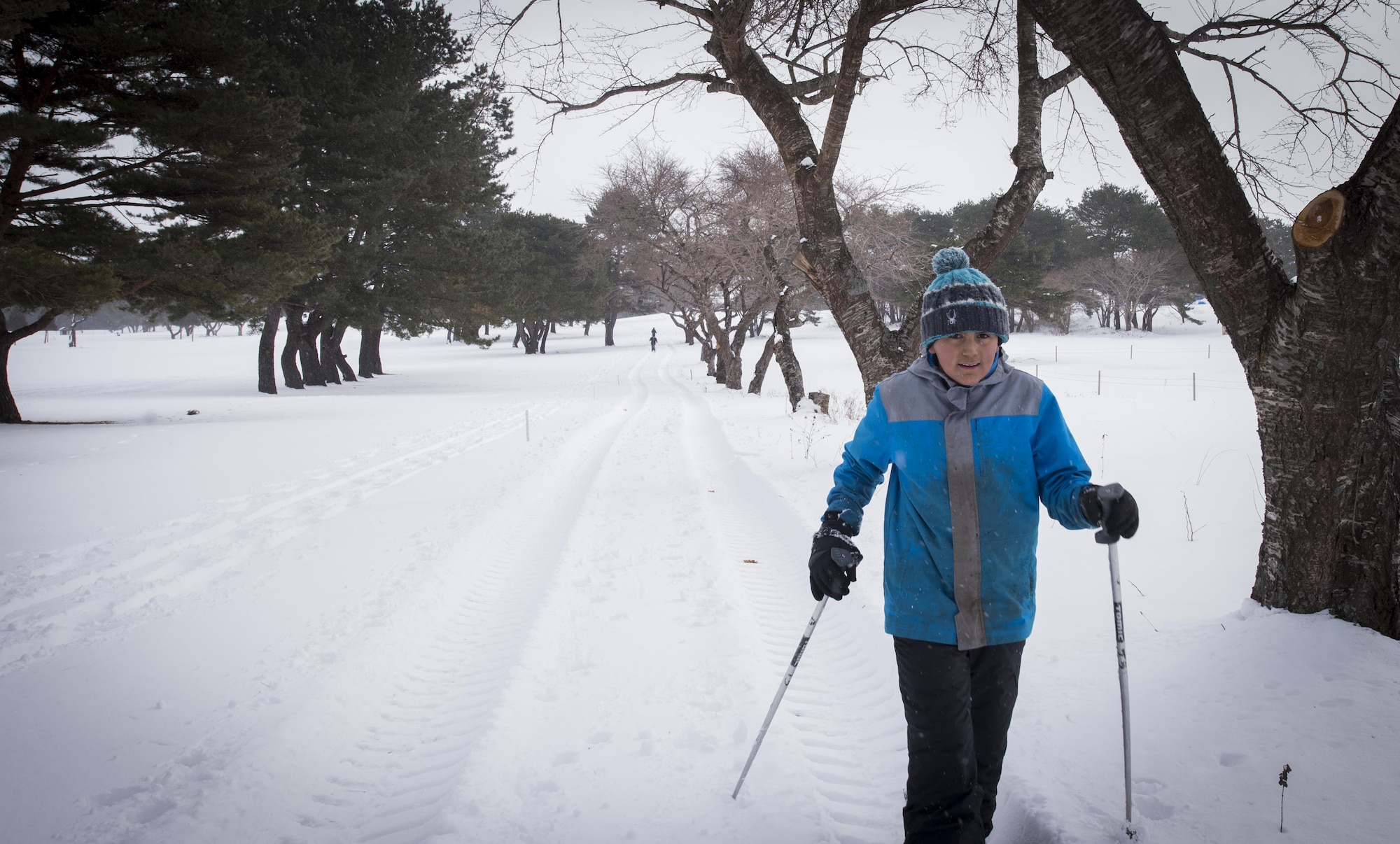 Ethan, son of Senior Master Sgt. Jeffery Sipos with the 35th Civil Engineer Squadron, cross country skis during the Klondike Derby at Misawa Air Base, Japan, Jan. 21, 2017. This was the last station of the day and one of the most difficult for the boys. The Klondike Derby taught tent setup, fire buring, first aid and other surival skills to help overcome the dangers of a cold environment. (U.S. Air Force photo by Tech Sgt. Araceli Alarcon)